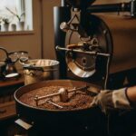 Coffee roasting setup showcasing a fluid bed roaster with green beans transforming into roasted coffee, emphasizing safety and best practices.